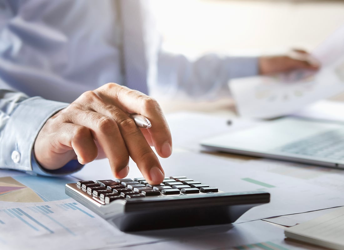 An accountant reviewing financial documents with a calculator