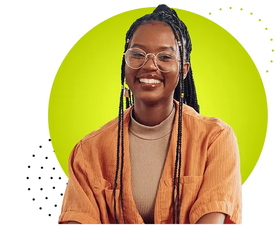 Portrait of a young woman wearing eyeglasses and long braided hair, smiling at the camera